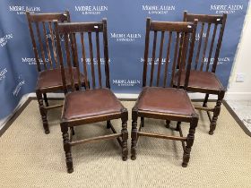 A set of four early 20th Century oak dinning chairs with bobbin turned front legs together with a