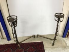 A pair of wrought iron ale muller fire dogs, 56 cm deep x 70 cm long,