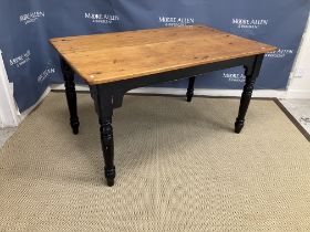 A Victorian pine and painted kitchen table the rectangular polished top on a black painted base,