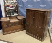 A mid 20th Century oak tallboy in the Gothic style with two cupboard doors above two drawers 85 cm