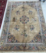 A Chinese superwash carpet, the central panel set with floral sprays on a beige ground,