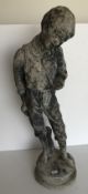 A 19th Century lead figure of a young street urchin with hand held out before him,