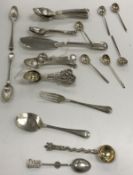 A collection of silver ware to include tea spoons, butter knife,