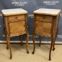 A pair of 20th Century French walnut grey veined white marble topped pot cupboards with drawers
