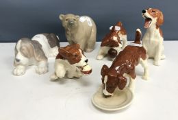 A set of four Beswick puppies, two with balls, one drinking from a dish, the tallest 11 cm high,
