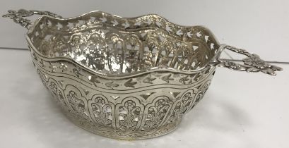 A Continental white metal twin handled basket of oval form with pierced and engraved foliate