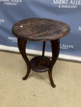 A Liberty carved teak circular occasional table with all over floral and foliate decoration on