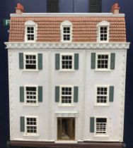 A Georgian style dolls' house, the front opening to reveal six rooms and a stairway,