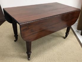 A late 19th Century mahogany dining table in the manner of Gillows with drop ends and four leaves,