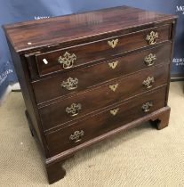 A George III mahogany bachelor's chest, the plain top with front half folding over on to lopers,