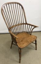 A modern ash and elm stick back Windsor chair on turned legs united by a crinoline stretcher,