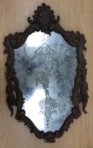 A pair of Continental engraved glass wall mirrors with figural decoration to the plate and carved