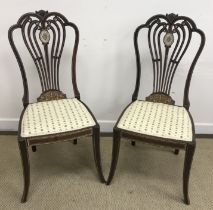 A pair of Edwardian mahogany ivorine and satinwood marquetry inlaid salon chairs,