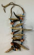 A Native American Piegan or Cheyenne Braves necklace made from Grisly Bear claws and teeth