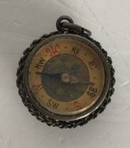 An Essex Crystal style compass, the reverse painted with a cyclist in blue and white top,