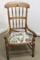 A Victorian stained beech framed spindle back open arm elbow chair on turned legs, 55 cm wide x 53.