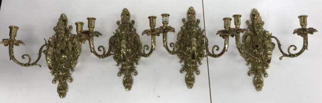 A set of four 20th Century brass twin light wall candle sconces in the Baroque style with Bacchus