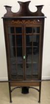 A mahogany and barber pole strung free-standing corner cabinet,