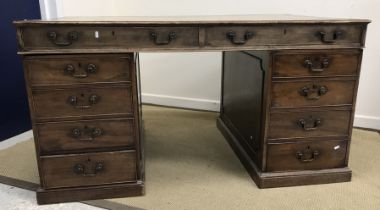 A mahogany double pedestal partners desk in the George III style,