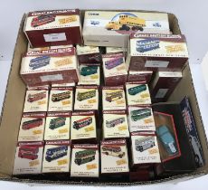 A box containing a collection of mainly modern boxed die-cast replica models of Great British Buses