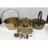 A collection of various copper and brass ware to include three iron-handled brass jam pans,