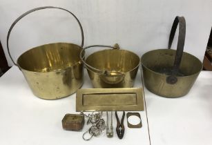 A collection of various copper and brass ware to include three iron-handled brass jam pans,