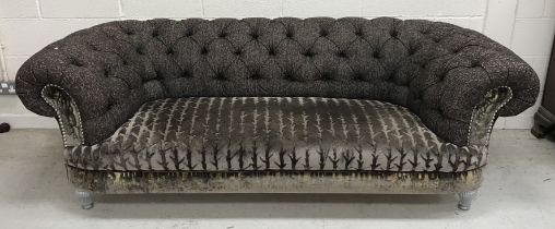 A modern buttoned upholstered Chesterfield sofa on silvered turned and reeded front legs,