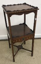 A 19th Century French ebonised rosewood cross-banded and floral marquetry inlaid three tier étagère