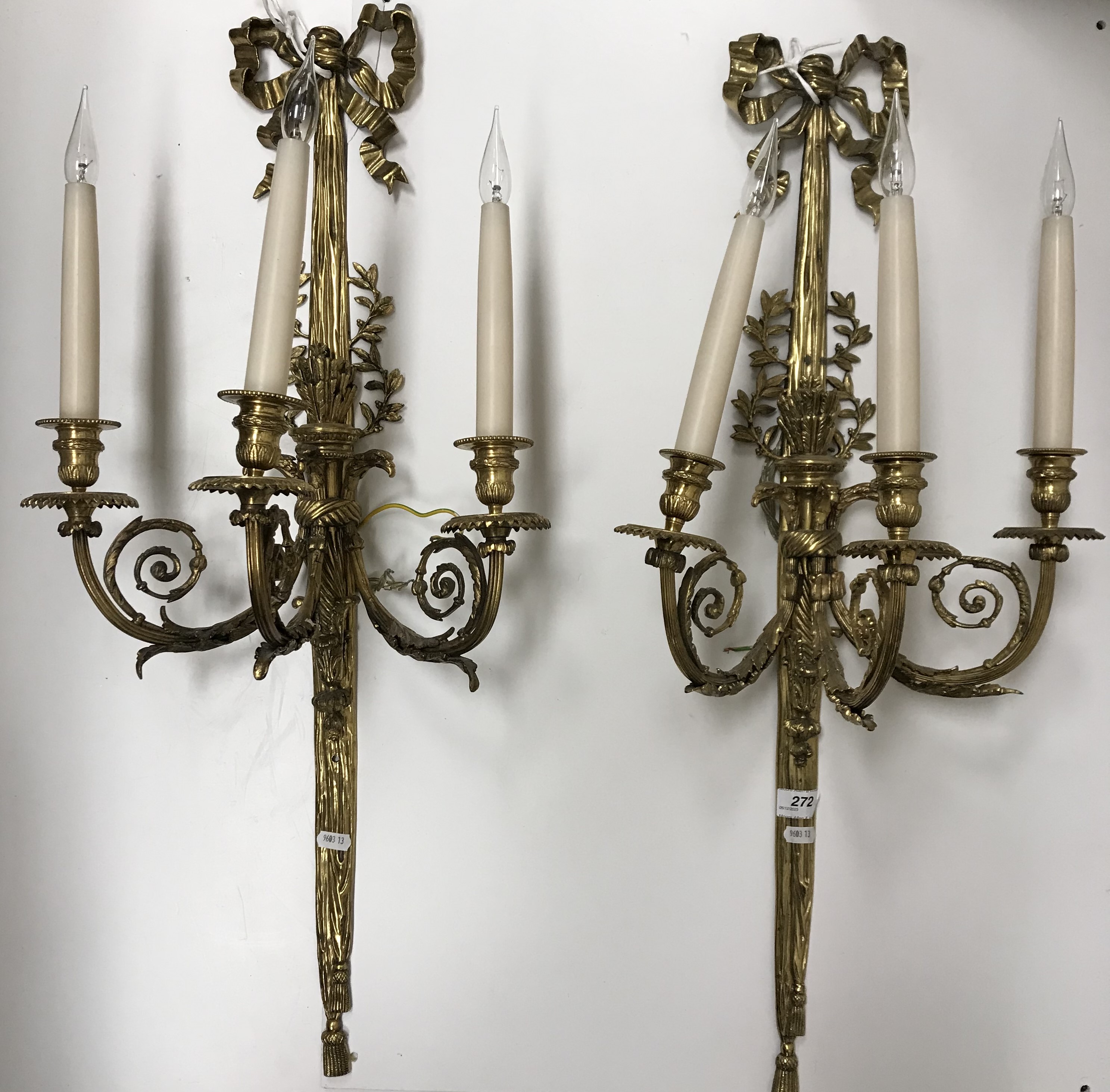 WITHDRAWN A pair of early 20th Century brass three branch wall lights in the Regency taste with