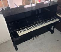 An ebonised cased upright piano, the iro
