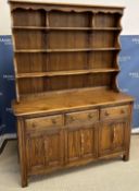 An Ercol elm dresser, the three tier boa