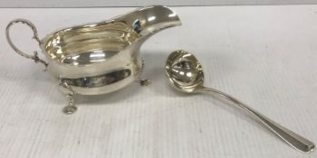 A George V silver sauceboat with scrolli