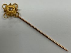 A yellow metal diamond set tie pin, 6 cm