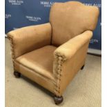 A circa 1900 upholstered arm chair on sq