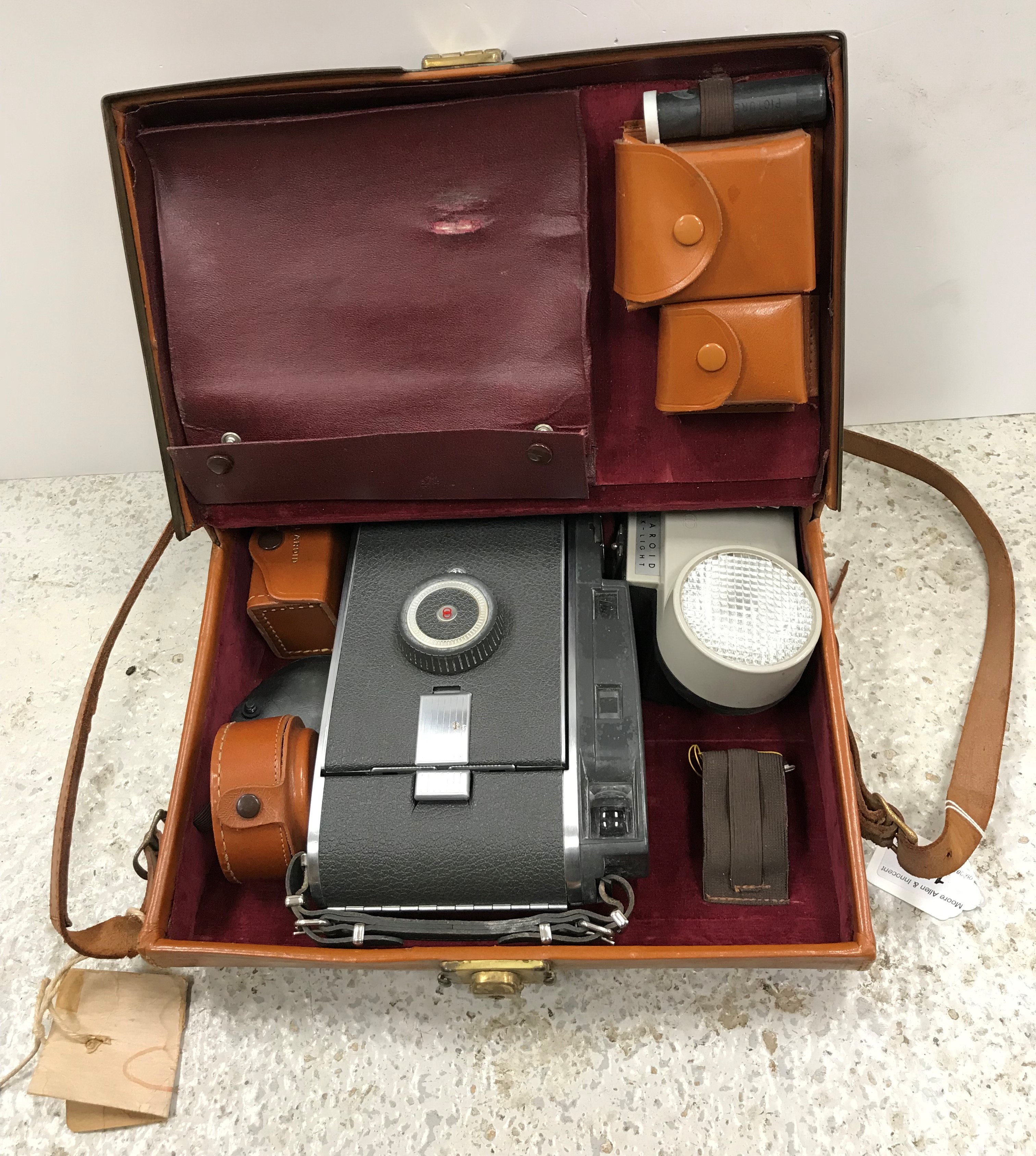 A Polaroid 10A camera in leather satchel