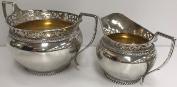 A George V silver cream jug and matching