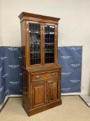 A late Victorian walnut secretaire bookcase cabinet, the upper section with leaded glazed doors