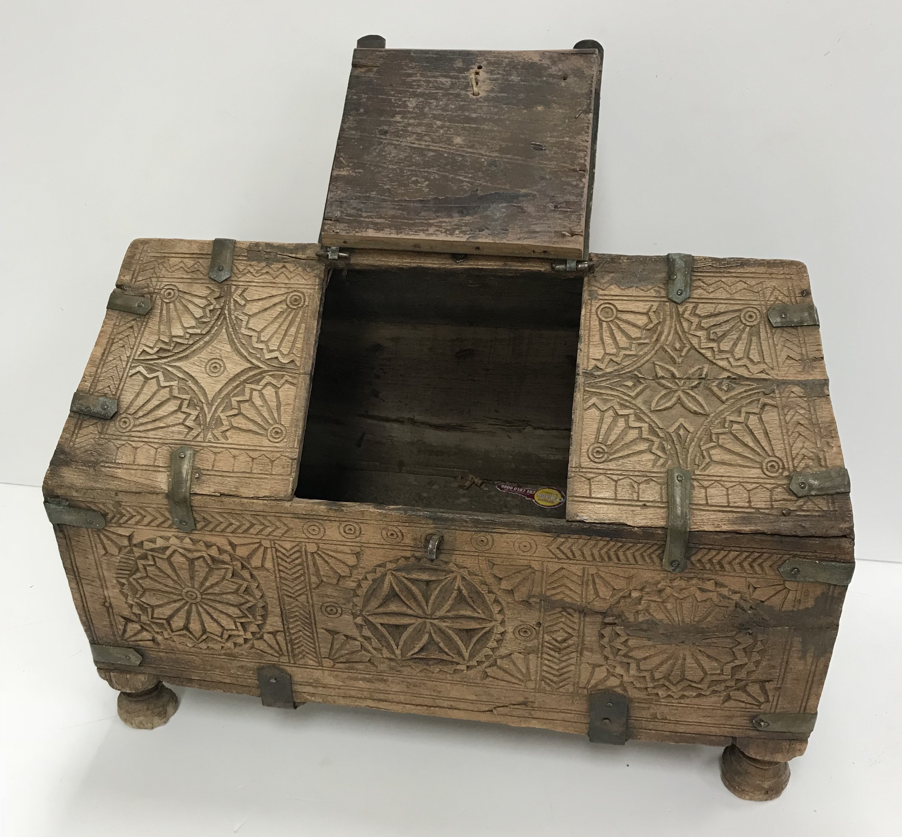 A vintage Indian Mughal dowry chest with carved medallion and brass bound decoration, raised on - Image 2 of 2