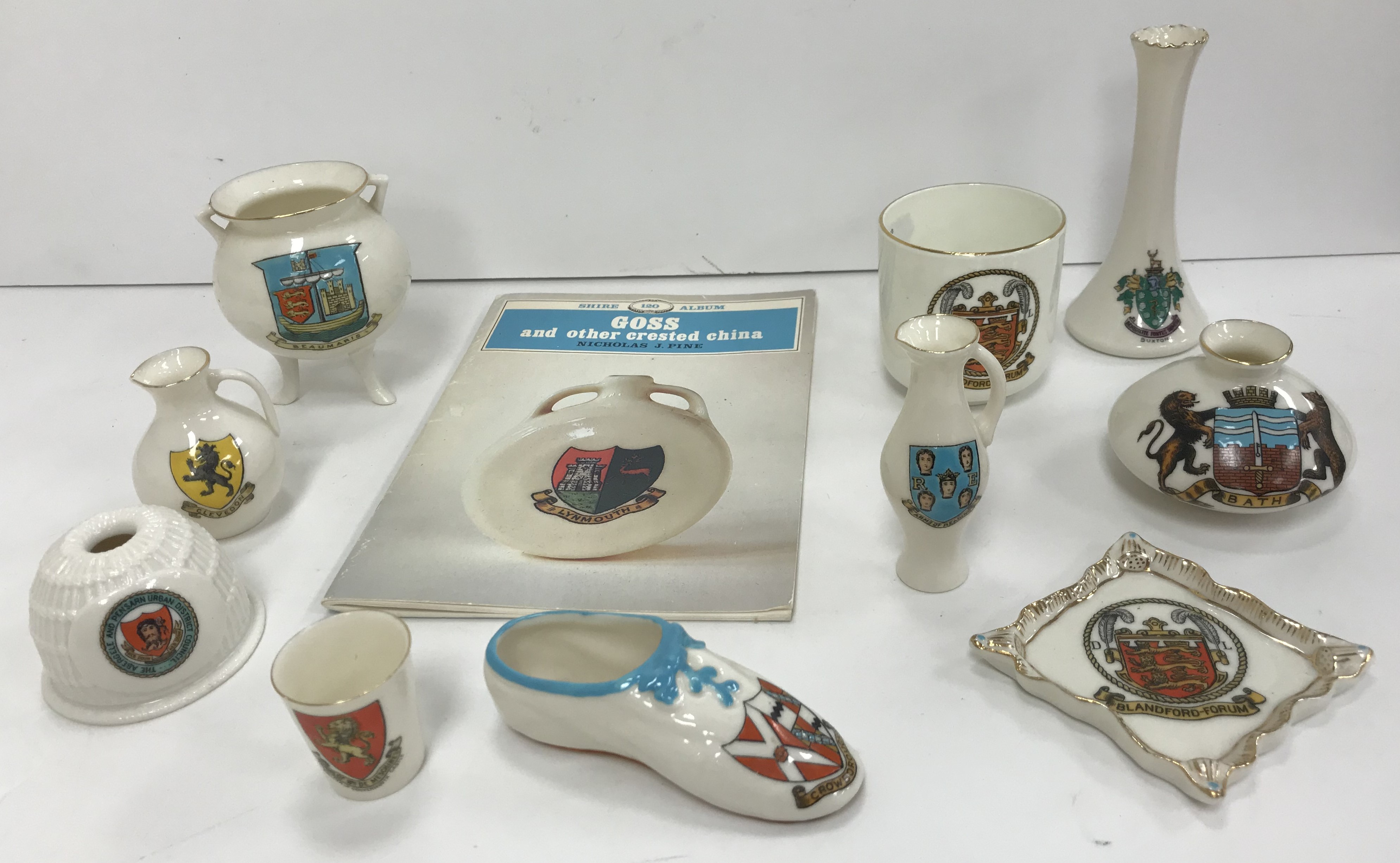 A collection of 65 WH Goss crested china items including Blandford-Forum, Weston-Super-Mare, Bath,