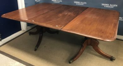 A late Regency mahogany dining table, the rounded rectangular top with moulded edge and single extra