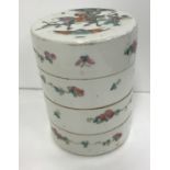 A circa 1900 Chinese porcelain stacking box of four sections in cylindrical form, the top