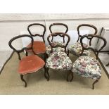 A set of six Victorian walnut and carved kidney back dining chairs with upholstered seats on