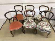 A set of six Victorian walnut and carved kidney back dining chairs with upholstered seats on