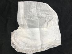 An 18th Century lace decorated floral cotton cap with double frill edge