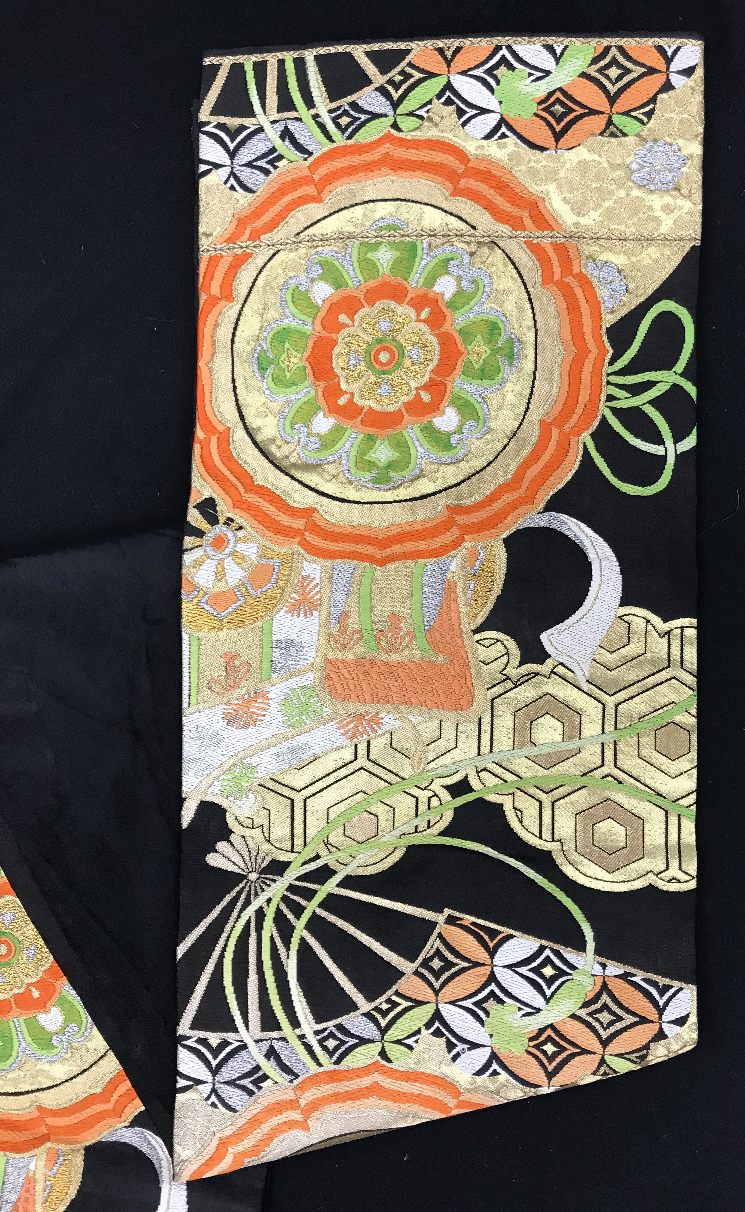 A late 20th Century Japanese obi belt with orange, green, white and gold fan and floral