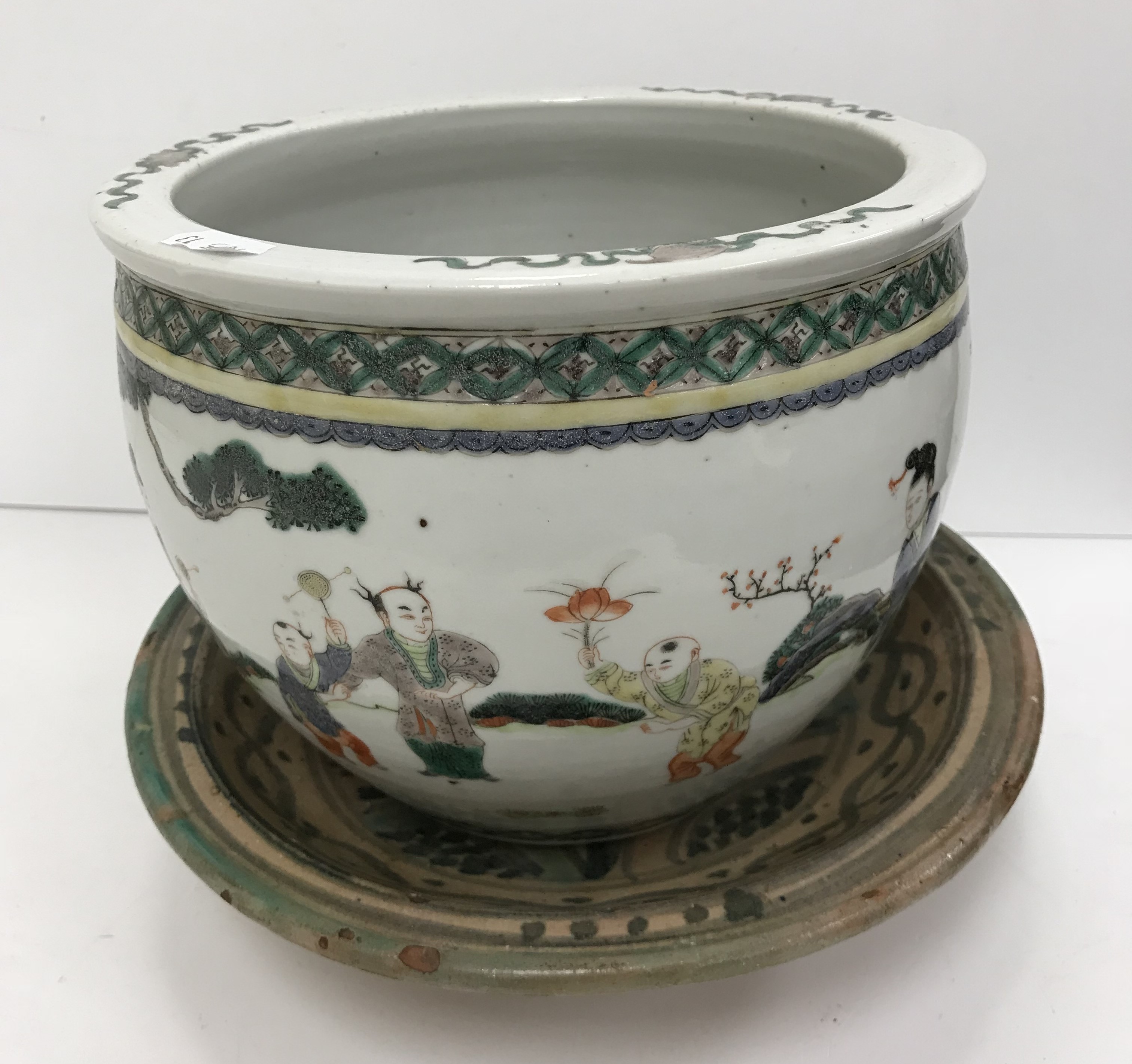 A 19th Century Chinese Kangxi palette jardiniere decorated with figures playing with various games