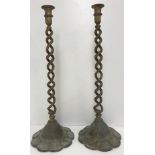 A pair of brass open barley-twist candlesticks on flower head textured foot, 56.5 cm high