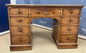 A Victorian mahogany kneehole desk, the plain top above a central drawer flanked by two banks of