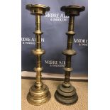 A large pair of brass ecclesiastical style altar type candlesticks with castellated drip trays on