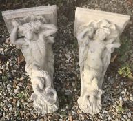 A pair of composite stone garden wall brackets as a merman and mermaid 53 cm long x 23 cm deep